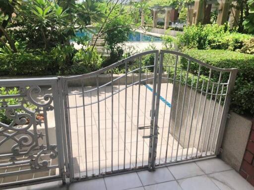 Outdoor area with pool view and metal gate