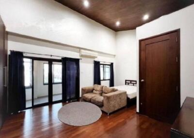 Bedroom with wooden flooring and modern furnishings