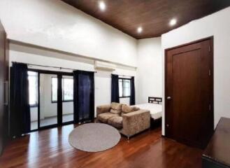 Bedroom with wooden flooring and modern furnishings