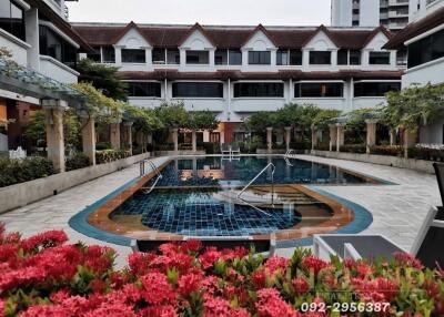 Courtyard with swimming pool surrounded by garden and buildings