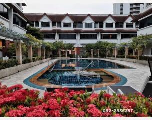 Courtyard with swimming pool surrounded by garden and buildings