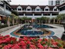 Courtyard with swimming pool surrounded by garden and buildings