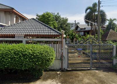 Front exterior view of property with gate and garden