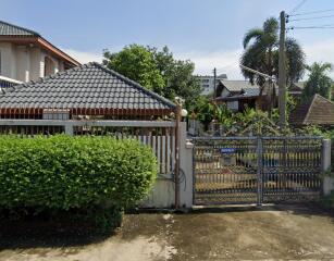 Front exterior view of property with gate and garden