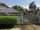 Front exterior view of property with gate and garden