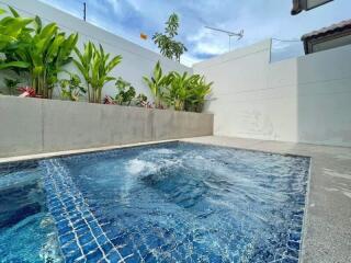 Beautiful backyard pool area with plants