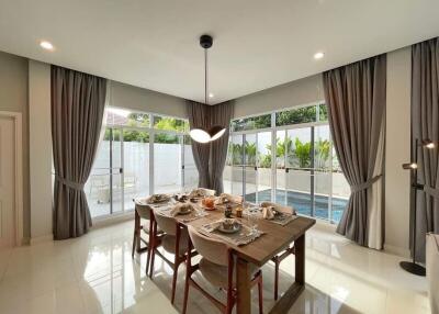 Dining room with large windows and pool view