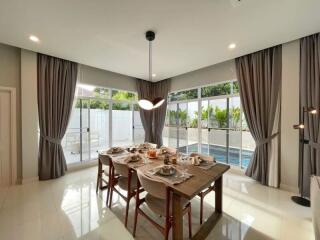 Dining room with large windows and pool view