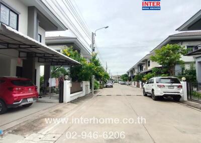 Street view of residential neighborhood with modern houses and parked cars