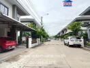 Street view of residential neighborhood with modern houses and parked cars