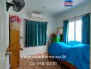 Bedroom with blue curtains and bed