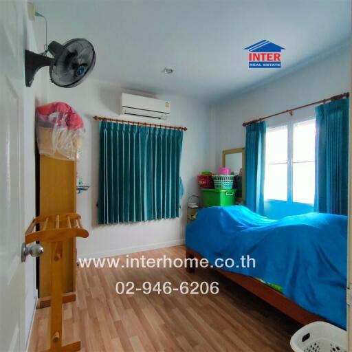 Bedroom with blue curtains and bed