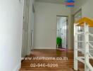 Interior hallway view leading to multiple rooms with wooden flooring