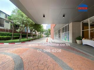 Entrance to building with driveway and covered walkway