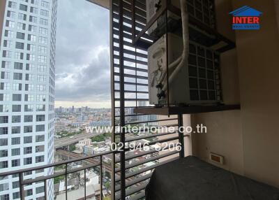 City view from a balcony with nearby high-rise buildings and air conditioning units