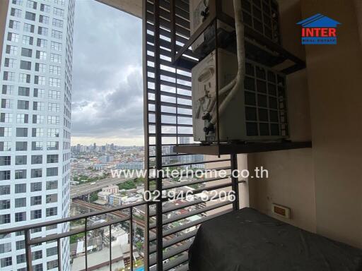 City view from a balcony with nearby high-rise buildings and air conditioning units