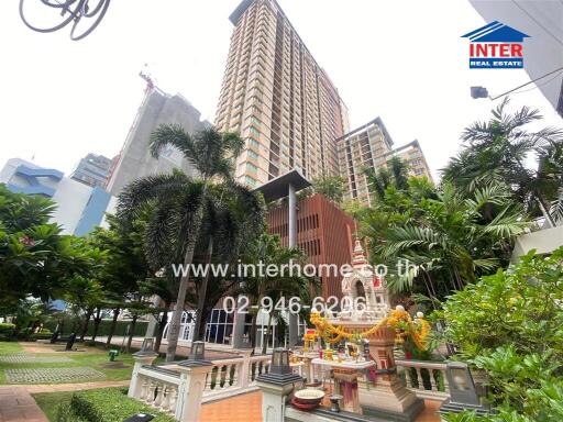 Exterior view of a residential building with garden and shrine