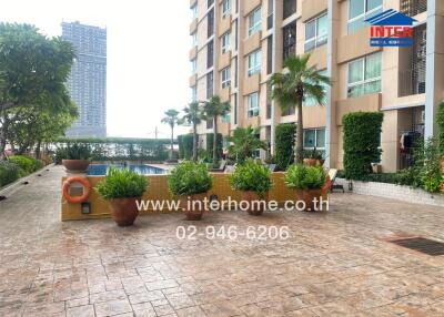 Outdoor view of a building with a swimming pool and garden area