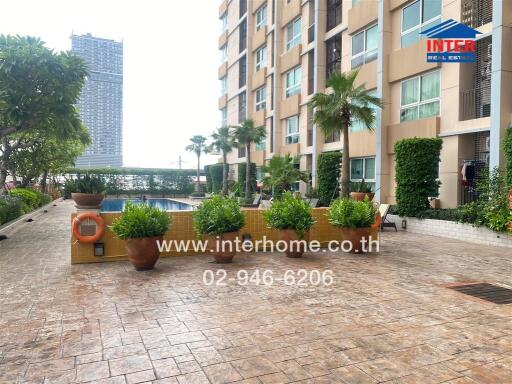 Outdoor view of a building with a swimming pool and garden area