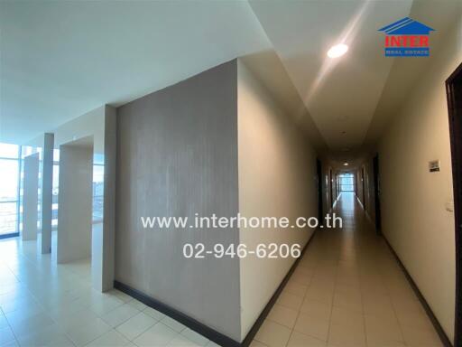 Hallway in a building with bright natural lighting and tiled floors