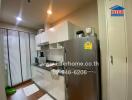 Modern kitchen with stainless steel appliances and ample lighting