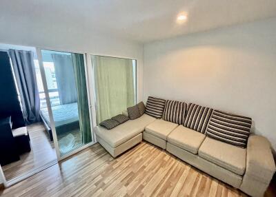 Spacious living room with L-shaped sofa and wooden flooring