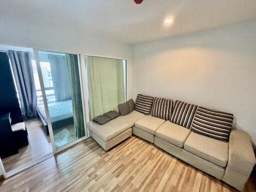 Spacious living room with L-shaped sofa and wooden flooring