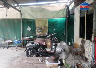 Garage area with motorcycle and various stored items