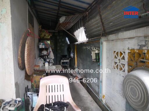 Outdoor utility area with a chair and household items