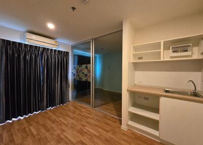 Open living space with kitchenette and sliding glass doors