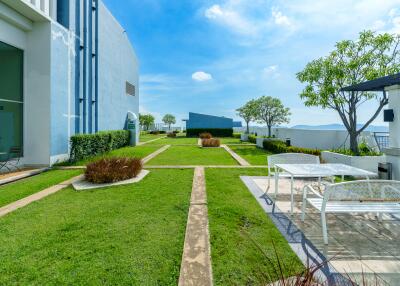 Modern building outdoor garden with seating area and blue sky