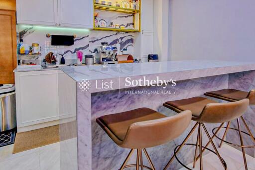 Modern kitchen with marble breakfast bar and bar stools