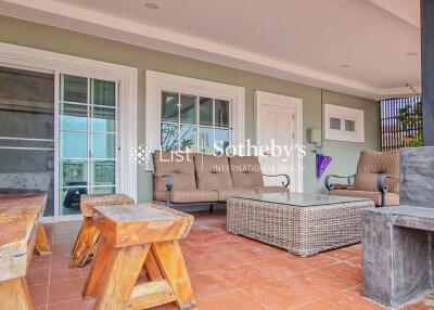 Outdoor living area with seating, coffee table, and hardwood features