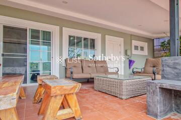 Outdoor living area with seating, coffee table, and hardwood features