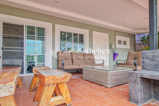 Outdoor living area with seating, coffee table, and hardwood features