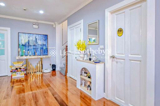 Modern hallway with white doors and wood flooring