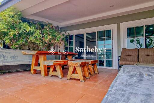 Patio with wooden furniture and sliding glass doors