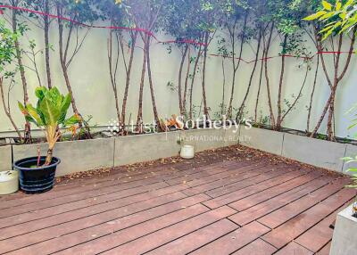 Spacious outdoor area with wooden deck and planters