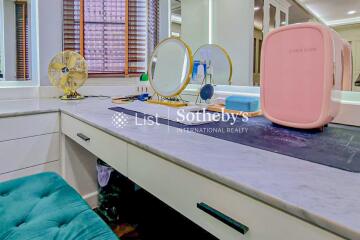 Vanity table with mirrors and various personal items