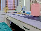 Vanity table with mirrors and various personal items