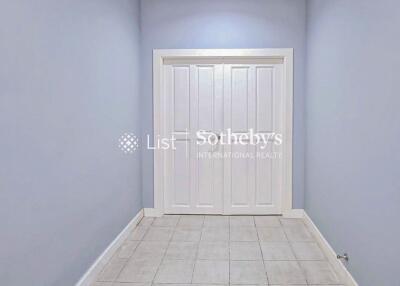 Hallway with double white doors and tiled floor