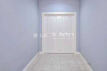 Hallway with double white doors and tiled floor