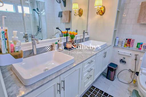 Modern double-sink bathroom with ample counter space and lighting