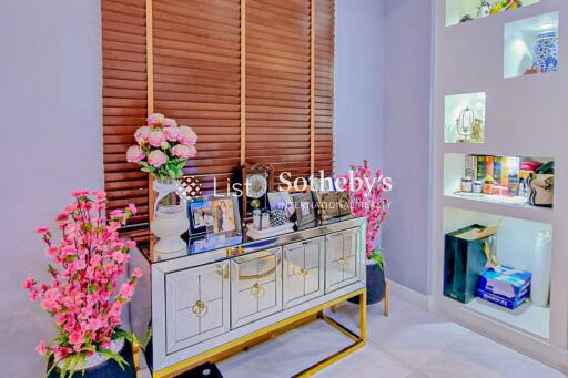 Decorated living space with decorative cabinet and open shelves