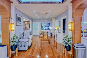 Spacious modern living room with wooden floor and recessed lighting