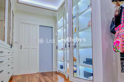 Spacious walk-in closet with illuminated display shelves