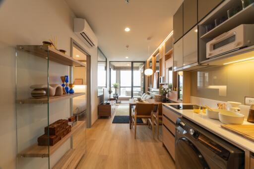 Modern kitchen and dining area with wooden flooring and contemporary furnishings