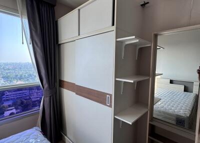 Bedroom with window, bed, wardrobe, and air conditioner