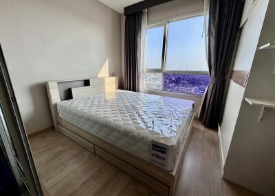 Modern bedroom with large window and city view