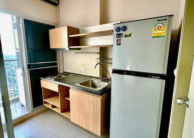 Compact kitchen with fridge and storage